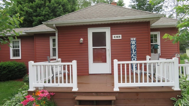 142 W Howard St, Galveston, IN 46932 - rear view of house featuring a deck, a shingled roof, and a chimney