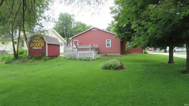 142 W Howard St, Galveston, IN 46932 - view of grassy yard featuring an outdoor structure and a deck