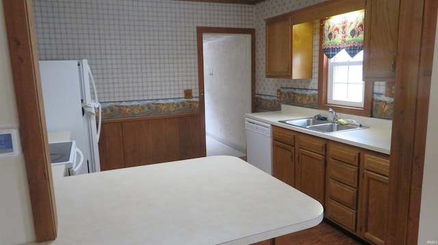 142 W Howard St, Galveston, IN 46932 - kitchen with white appliances, wallpapered walls, light countertops, brown cabinetry, and a peninsula
