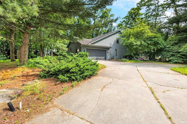 10880 Cougar Dr, Granger, IN 46530 - view of side of property featuring concrete driveway and an attached garage