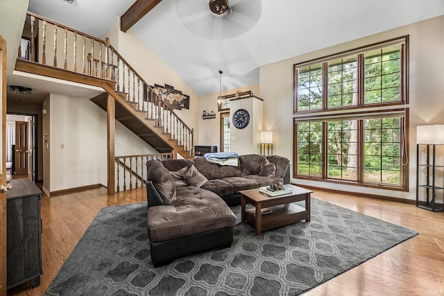 10880 Cougar Dr, Granger, IN 46530 - living room with high vaulted ceiling, wood finished floors, ceiling fan, beamed ceiling, and stairway
