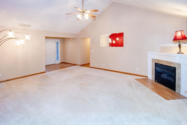 9040 Clear Creek Dr, Evansville, IN 47711 - unfurnished living room with carpet floors, a ceiling fan, a glass covered fireplace, and high vaulted ceiling