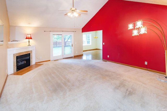 9040 Clear Creek Dr, Evansville, IN 47711 - unfurnished living room with carpet flooring, a ceiling fan, a tiled fireplace, and high vaulted ceiling