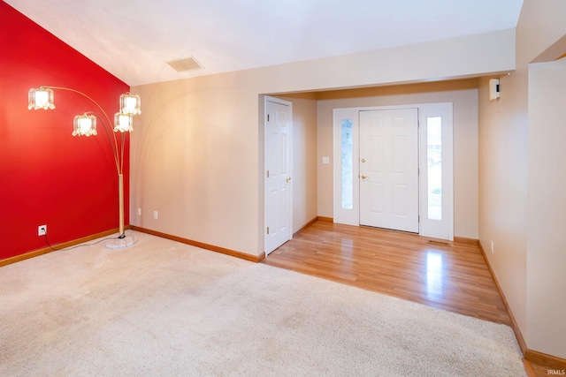9040 Clear Creek Dr, Evansville, IN 47711 - foyer with carpet floors and wood finished floors
