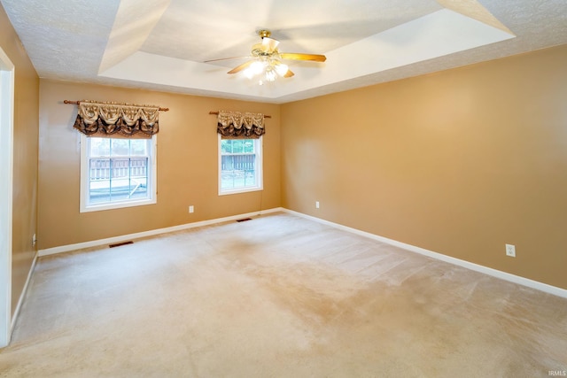 9040 Clear Creek Dr, Evansville, IN 47711 - spare room featuring a raised ceiling, ceiling fan, and light colored carpet