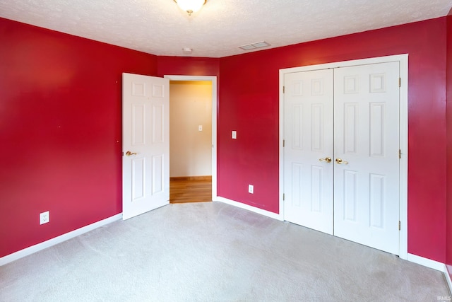 9040 Clear Creek Dr, Evansville, IN 47711 - unfurnished bedroom with carpet flooring, a closet, and a textured ceiling