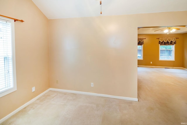 9040 Clear Creek Dr, Evansville, IN 47711 - empty room featuring light colored carpet, ceiling fan, and vaulted ceiling