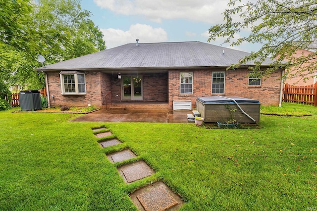 9040 Clear Creek Dr, Evansville, IN 47711 - rear view of house with a hot tub, brick siding, and a patio area