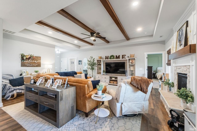 10251 Fieldlight Blvd, Fort Wayne, IN 46835 - living room with wood finished floors, ceiling fan, beam ceiling, a stone fireplace, and recessed lighting