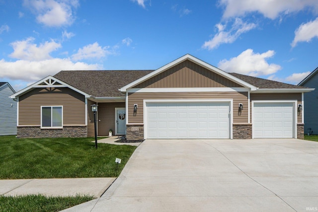 10251 Fieldlight Blvd, Fort Wayne, IN 46835 - view of front facade featuring stone siding, an attached garage, driveway, and a front yard