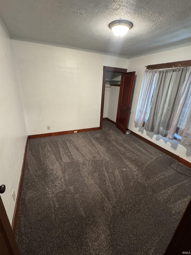 3316 Central Dr, Fort Wayne, IN 46806 - unfurnished bedroom featuring a textured ceiling, dark carpet, and a closet