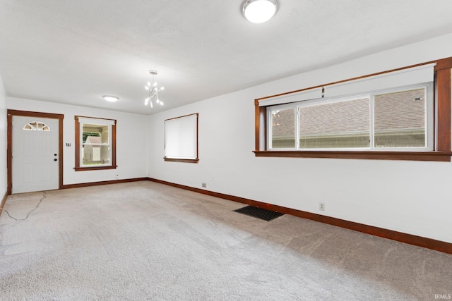 3316 Central Dr, Fort Wayne, IN 46806 - empty room with carpet flooring, healthy amount of natural light, and a chandelier