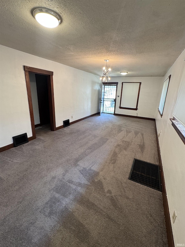 3316 Central Dr, Fort Wayne, IN 46806 - empty room with carpet floors, a textured ceiling, and a chandelier