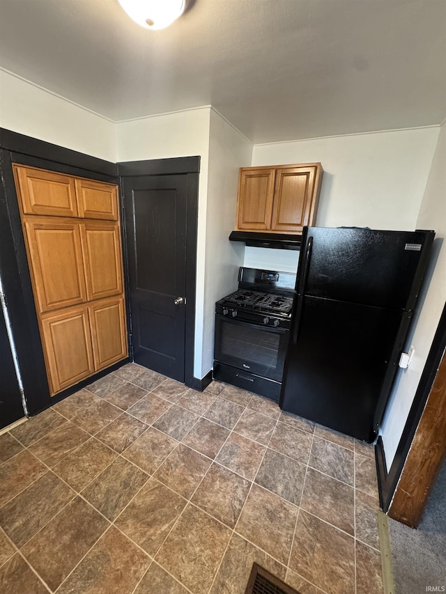3316 Central Dr, Fort Wayne, IN 46806 - kitchen with black appliances, under cabinet range hood, brown cabinetry, and stone finish floors