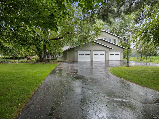 2107 W 450 S, Lafayette, IN 47909 - view of front of house with asphalt driveway, a front yard, and a garage