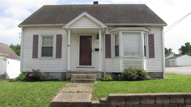 230 W Morton St, Oakland City, IN 47660 - view of front facade with entry steps, a front yard, a chimney, and roof with shingles