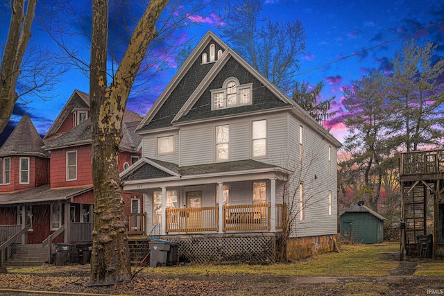 641 W Lexington Ave, Elkhart, IN 46514 - view of front of house with covered porch, a storage unit, and stairs