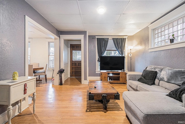 641 W Lexington Ave, Elkhart, IN 46514 - living area featuring a textured wall, light wood finished floors, and a paneled ceiling