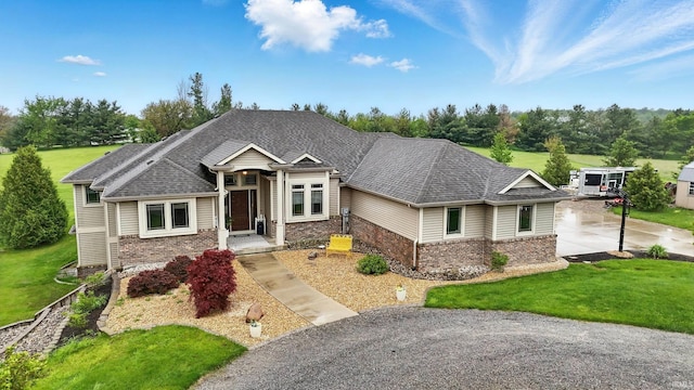 3908 County Road 4, Ashley, IN 46705 - view of front facade featuring brick siding, a front yard, and view of wooded area