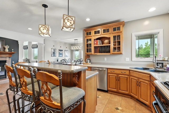 3908 County Road 4, Ashley, IN 46705 - kitchen with stainless steel dishwasher, a kitchen bar, light tile patterned flooring, healthy amount of natural light, and recessed lighting