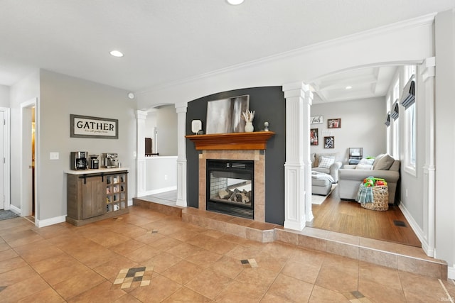 3908 County Road 4, Ashley, IN 46705 - living area featuring decorative columns, light tile patterned floors, recessed lighting, a tile fireplace, and ornamental molding