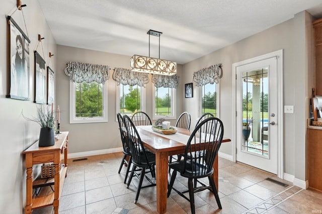3908 County Road 4, Ashley, IN 46705 - dining area with plenty of natural light and light tile patterned floors