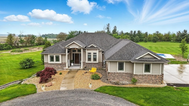 3908 County Road 4, Ashley, IN 46705 - view of front of home featuring brick siding, a front lawn, and a shingled roof