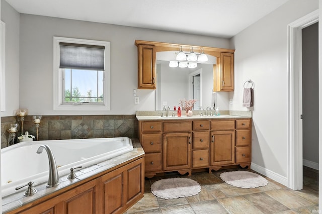 3908 County Road 4, Ashley, IN 46705 - bathroom with double vanity, a whirlpool tub, stone finish flooring, and a chandelier