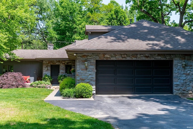 24413 Mckelvey Ave, Elkhart, IN 46516 - view of front of home with stone siding, a garage, and asphalt driveway