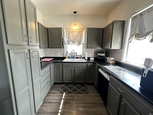 419 W Jefferson St, Kokomo, IN 46901 - kitchen with dishwasher, dark countertops, dark wood-style floors, tasteful backsplash, and hanging light fixtures