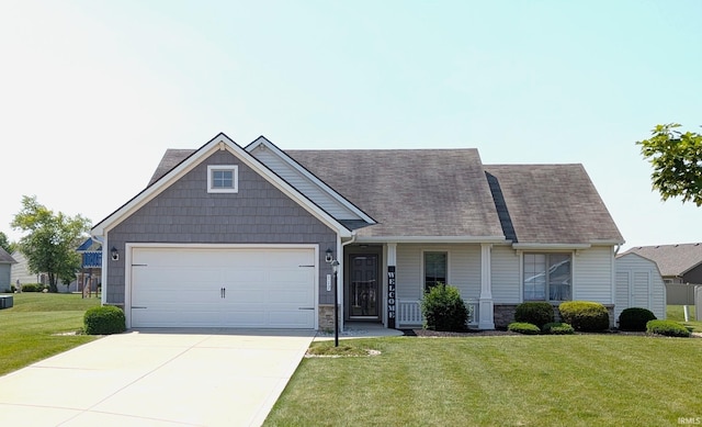 117 Blue Heron Cv, Decatur, IN 46733 - view of front facade featuring a front lawn, an attached garage, stone siding, and driveway