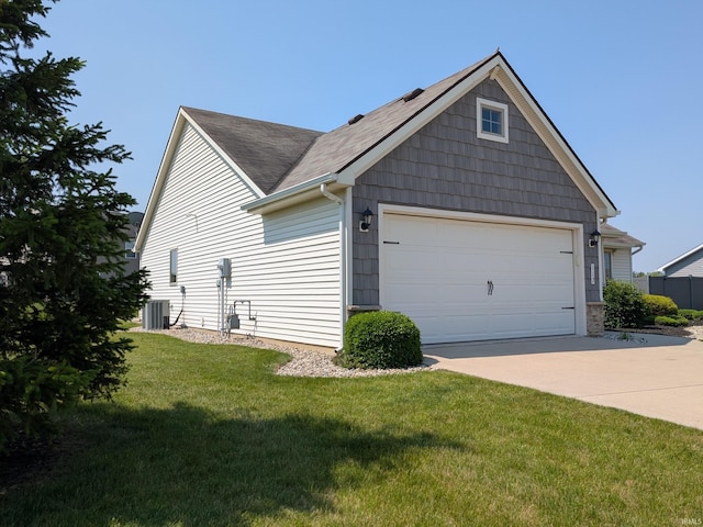 117 Blue Heron Cv, Decatur, IN 46733 - view of side of home with driveway, a lawn, a shingled roof, and an attached garage