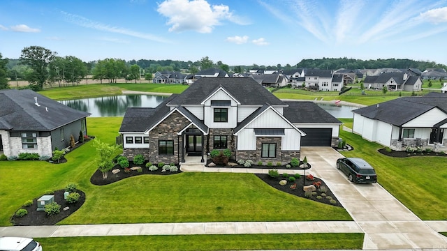 13176 Malfini Trl, Fort Wayne, IN 46845 - view of front of property featuring stone siding, driveway, a water view, a residential view, and a shingled roof