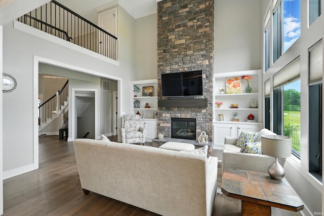 13176 Malfini Trl, Fort Wayne, IN 46845 - living area with a high ceiling, a fireplace, dark wood-style floors, and stairway