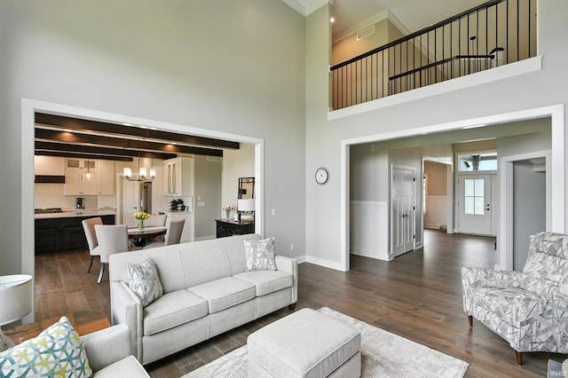 13176 Malfini Trl, Fort Wayne, IN 46845 - living area with a towering ceiling, a chandelier, dark wood-style flooring, and ornamental molding