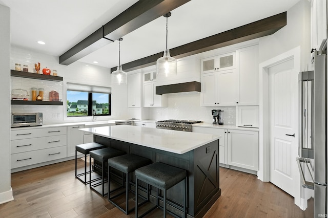 13176 Malfini Trl, Fort Wayne, IN 46845 - kitchen with tasteful backsplash, a kitchen bar, dark wood-style flooring, white cabinetry, and light countertops