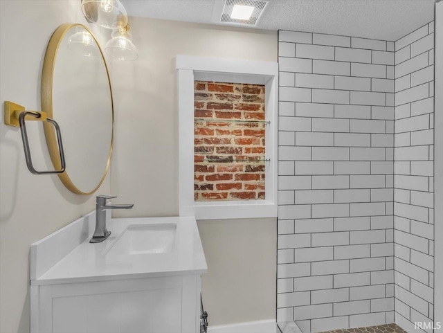 439 E Wayne St, Fort Wayne, IN 46802 - bathroom featuring vanity, a tile shower, and a textured ceiling