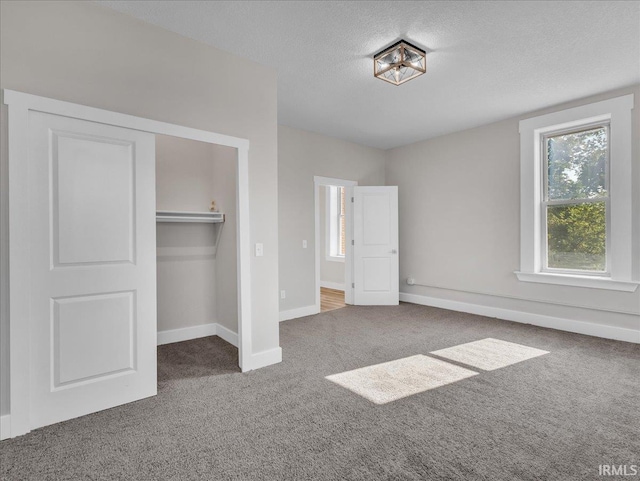 439 E Wayne St, Fort Wayne, IN 46802 - unfurnished bedroom with carpet flooring, a textured ceiling, and a closet