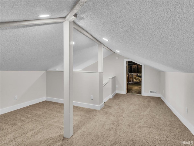 439 E Wayne St, Fort Wayne, IN 46802 - additional living space with a textured ceiling, vaulted ceiling, and carpet flooring