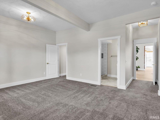 439 E Wayne St, Fort Wayne, IN 46802 - unfurnished bedroom featuring carpet floors, beam ceiling, and a textured ceiling