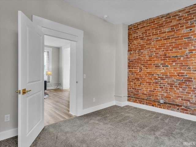 439 E Wayne St, Fort Wayne, IN 46802 - spare room featuring carpet flooring, a smoke detector, and brick wall