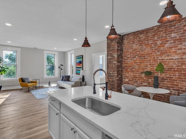 439 E Wayne St, Fort Wayne, IN 46802 - kitchen with open floor plan, light wood-style floors, pendant lighting, light stone countertops, and recessed lighting