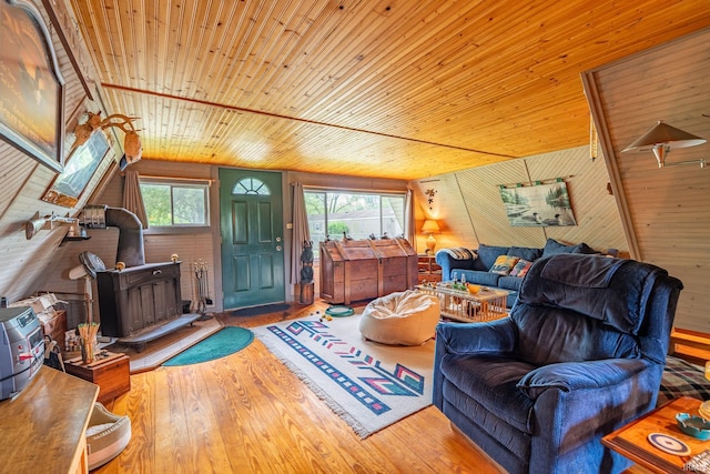 5142 W Corly Ln, Silver Lake, IN 46982 - living area featuring a wood stove, wood ceiling, wood finished floors, wood walls, and vaulted ceiling