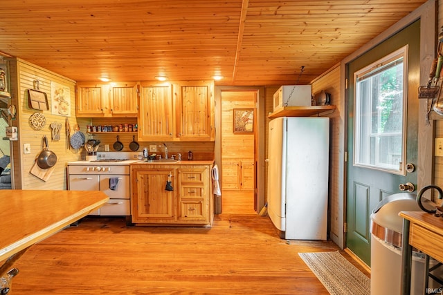 5142 W Corly Ln, Silver Lake, IN 46982 - kitchen featuring freestanding refrigerator, wood ceiling, light countertops, light wood-style floors, and wood walls