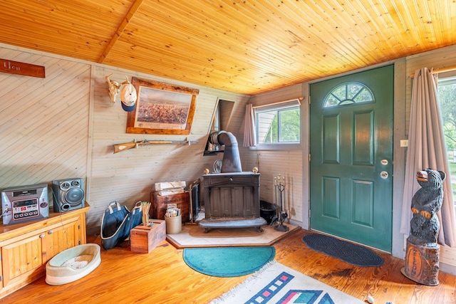 5142 W Corly Ln, Silver Lake, IN 46982 - foyer entrance with a wood stove, wooden ceiling, wood finished floors, and wood walls