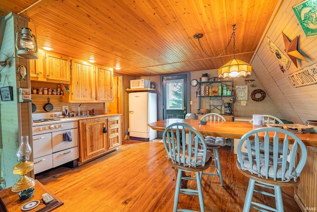 5142 W Corly Ln, Silver Lake, IN 46982 - kitchen featuring white appliances, wooden ceiling, light wood-style flooring, light countertops, and wood walls