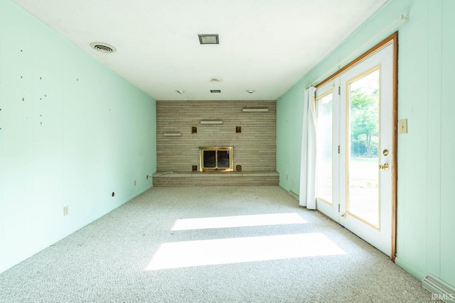 644 W Ladd Ave, Bloomington, IN 47403 - unfurnished living room featuring a brick fireplace and carpet