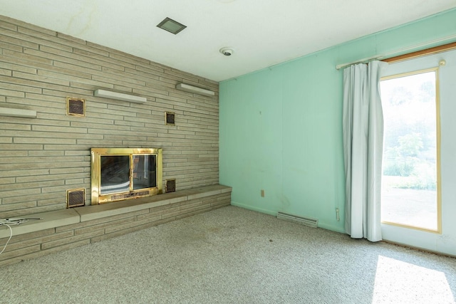 644 W Ladd Ave, Bloomington, IN 47403 - unfurnished living room with a brick fireplace, carpet flooring, and healthy amount of natural light