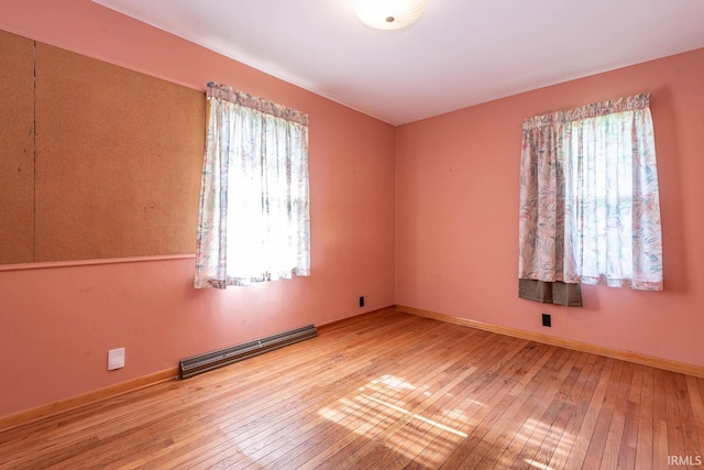 644 W Ladd Ave, Bloomington, IN 47403 - unfurnished room with a baseboard radiator and hardwood / wood-style flooring