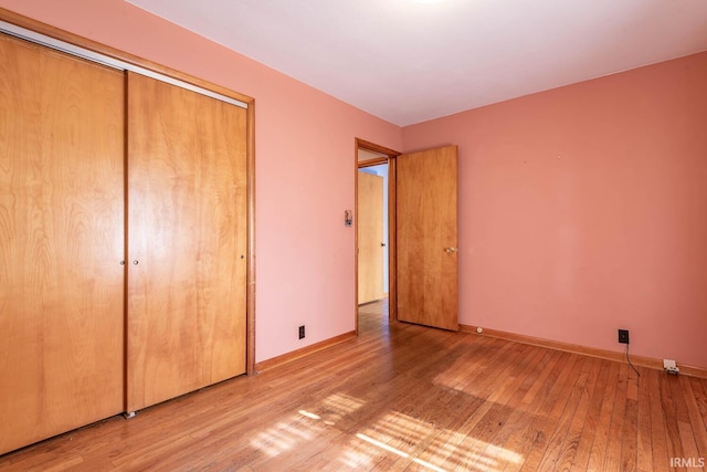 644 W Ladd Ave, Bloomington, IN 47403 - unfurnished bedroom featuring light wood finished floors and a closet